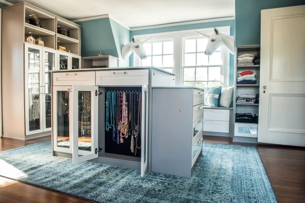 A walk-in closet with an island