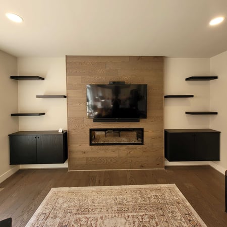 Entertainment center around a fireplace with floating shelves