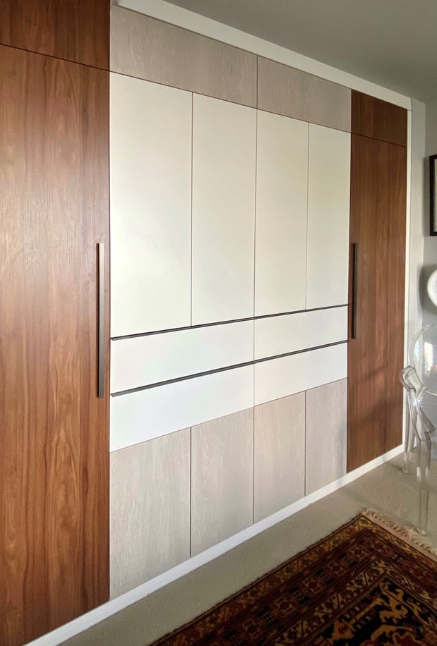 Side angle view of wardrobe built to appear flush with the wall