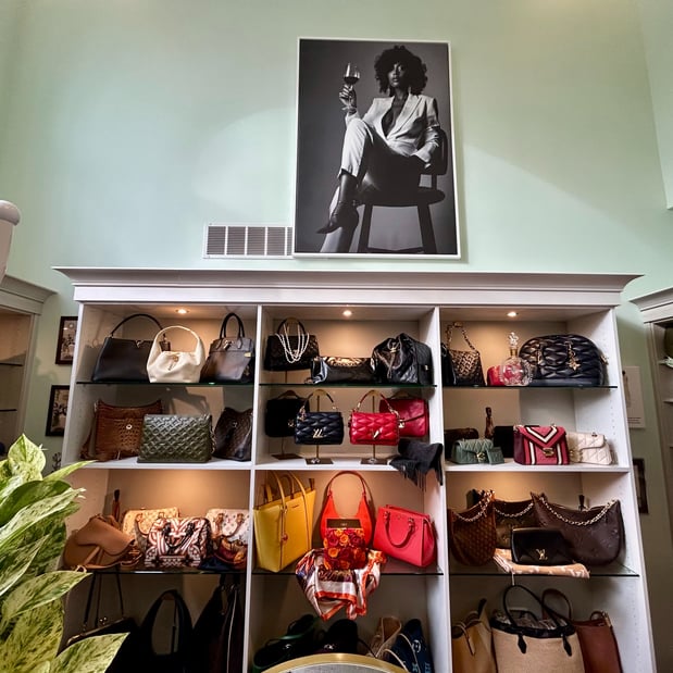 Walk In Closet with custom shelving for purse storage and accessory storage by California Closets Toledo.