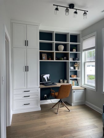 Home office with custom storage, including bookshelf with cabinets by California Closets Albany, New York.