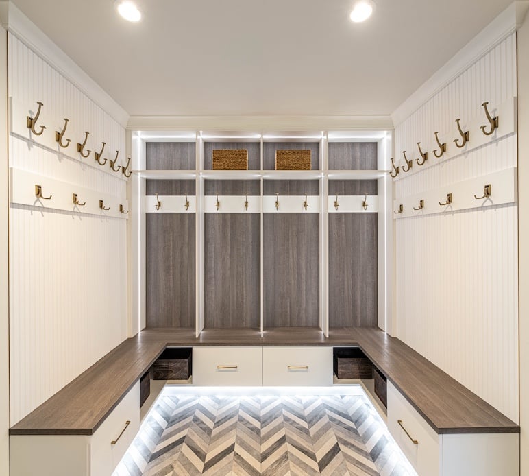 herringbone flooring, mudroom, custom mudroom, family mudroom, grey wood, grey back paneling, grey and white wood, gold hardware, gold hooks, mudroom lighting, canton, Michigan
