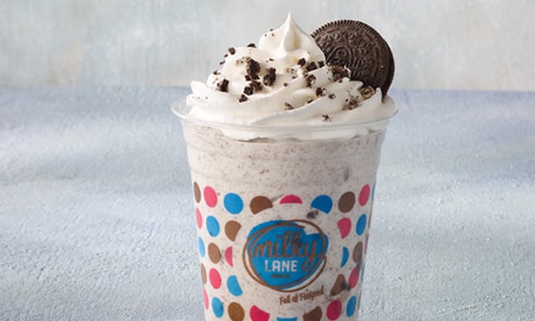 Milkyshake with crushed biscuits and an OREO® cookie in a transparent plastic cup