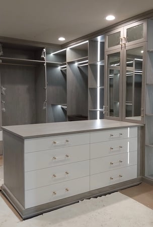 Custom walk in closet with integrated storage island, shelving, and custom closet organization. Birmingham, Michigan