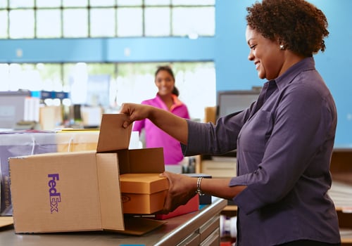 FedEx employee packaging a shipment