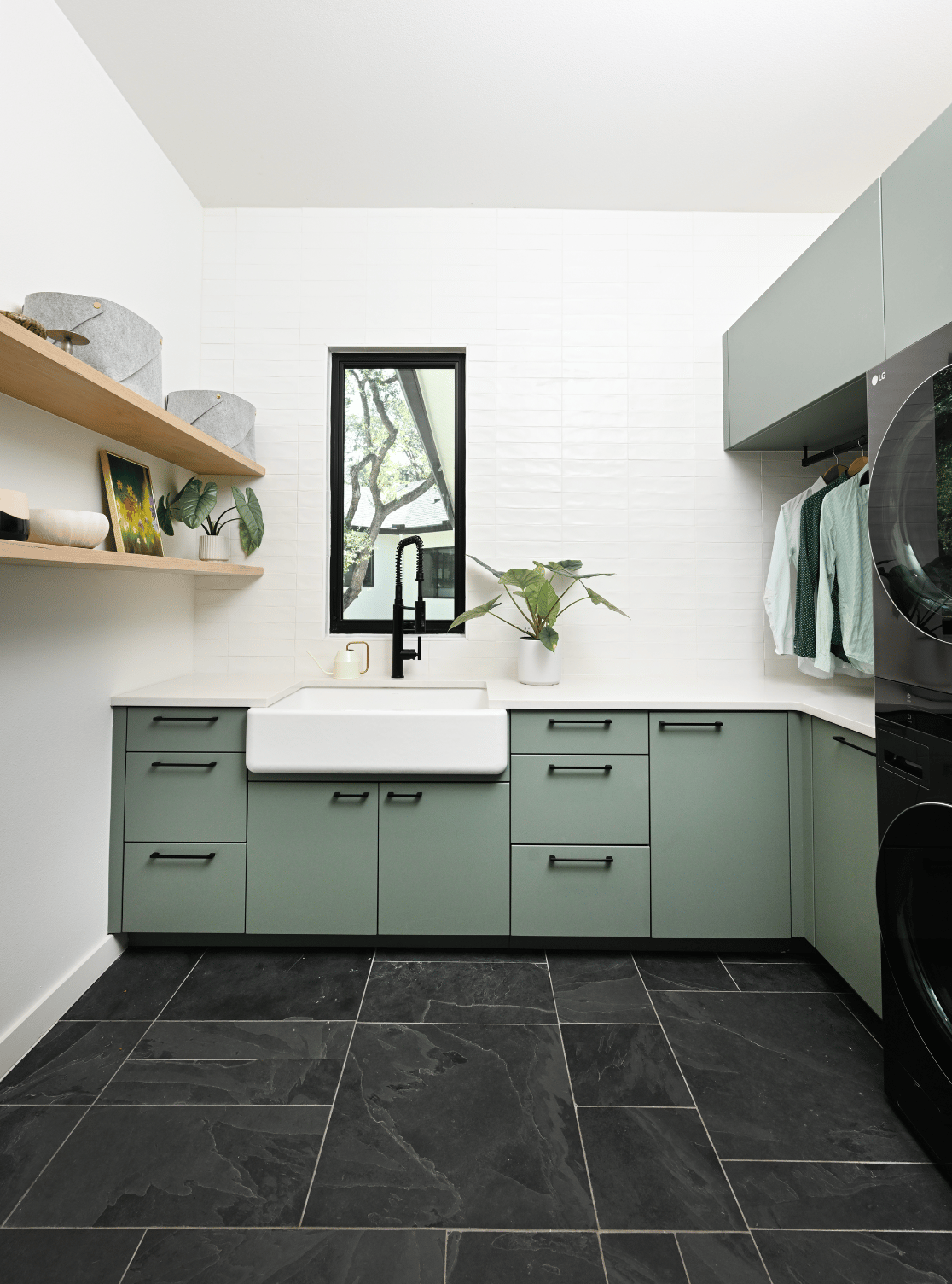 Luxurious laundry room by California Closets Austin, featuring custom drawers and doors, and a hanging area for optimal organization and style.