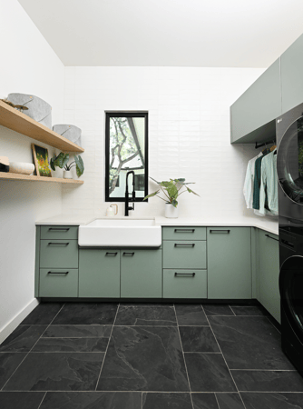 Luxurious laundry room by California Closets Austin, featuring custom drawers and doors, and a hanging area for optimal organization and style.