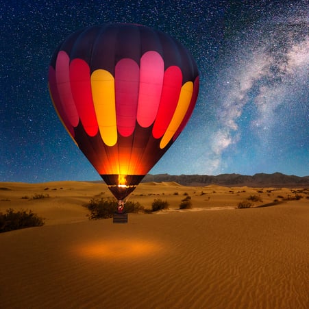 Hot air ballon flying at night.