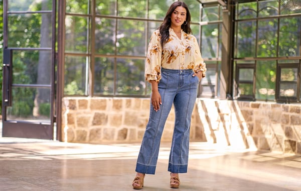 Woman is wearing plus size flare jeans.