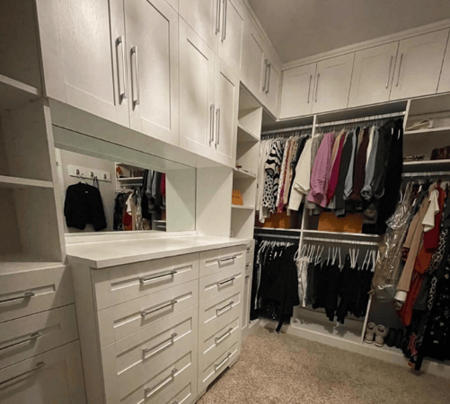 Closet with hanging space, shelving, drawers, and cabinets.