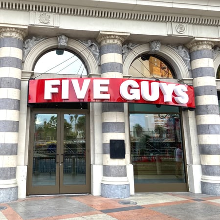 Exterior photograph of the Five Guys restaurant at 3377 South Las Vegas Boulevard in Las Vegas, Nevada.