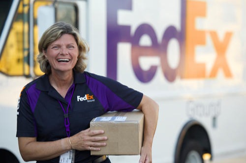 FedEx Ground employee holding a package