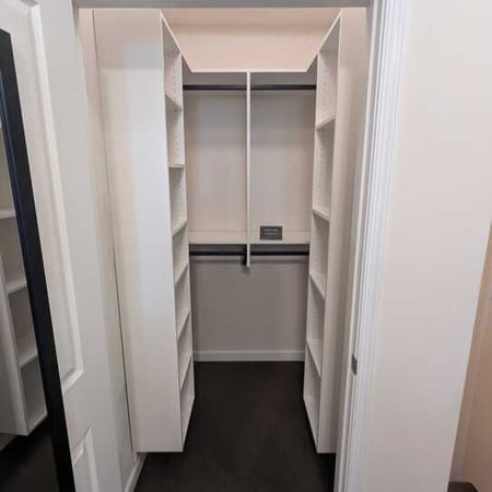 Virginia Beach - Custom closets - Narrow walk-in closet with shelving and hanging rods on both sides.