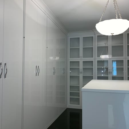 LUXE DRESSING ROOM with GLOSS WHITE GLASS DOORS, an ISLAND and CRYSTAL HANDLES