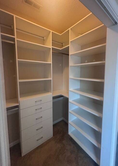 Virginia Beach - Custom closets - Walk-in closet with white shelving, drawers, and double hanging rods.