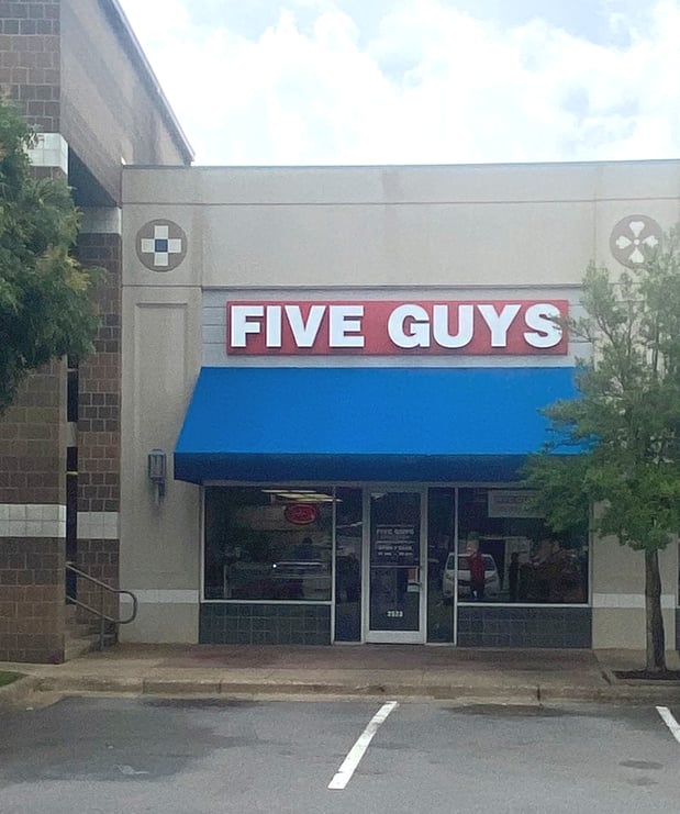 Exterior photograph of the Five Guys restaurant at 2923 Lakewood Village Drive in North Little Rock, Arkansas.