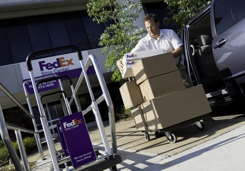 Man unloading packages at FedEx Ship Centre
