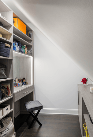 Img 3 California Closets Armonk New York Gray Walk-in Closet with Angled sloped ceiling, Vanity with Built-in Lighting and Custom Shelving Storage