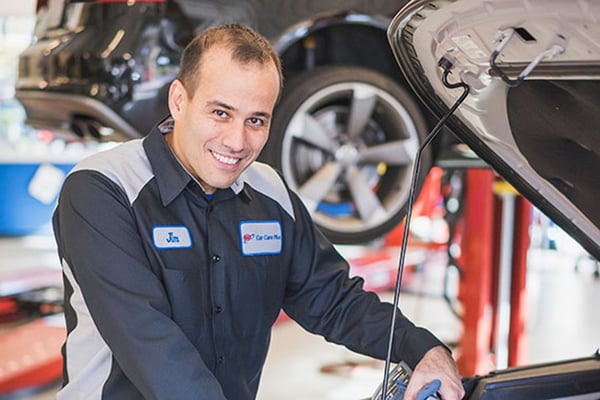 a AAA auto repair mechanic works on a car at an auto repair center