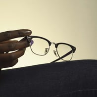 Hand holding Ray-Ban eyeglasses