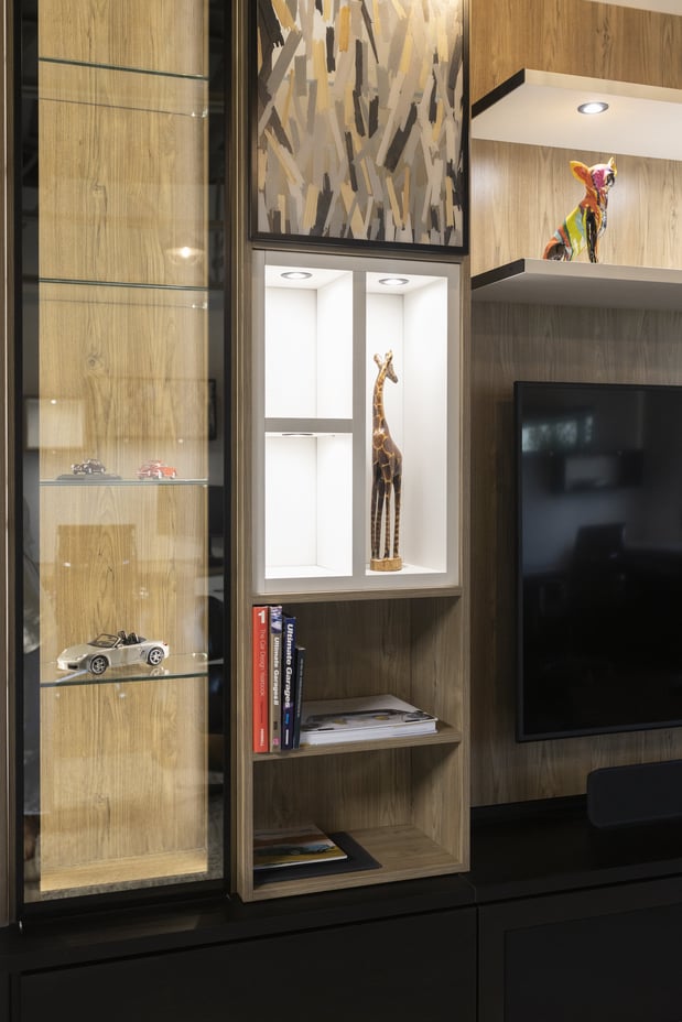 Custom media center with glass cabinetry and shelving by California Closets Edmonton, Alberta.