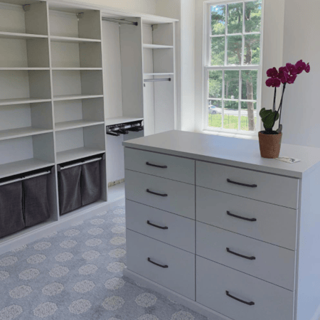 Custom Walk-In Closet with Hampers Drawers and Custom Island with Countertop in Lewes, DE by California Closets of Philadelphia and Delaware