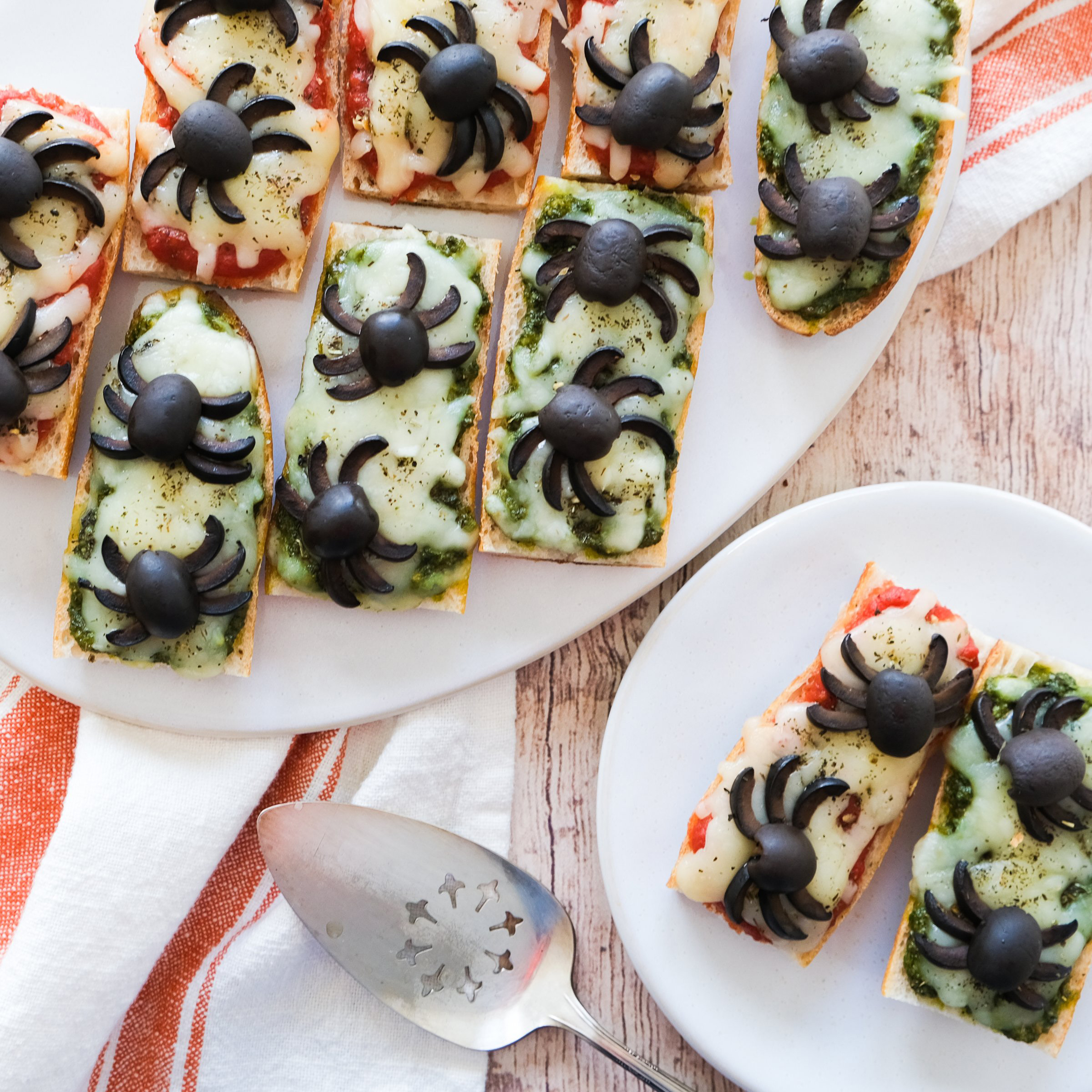 tomato and basil pesto baguette pizzas with black live spiders