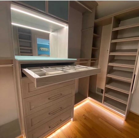 grey closet with drawers, mirror, shelves and lighting