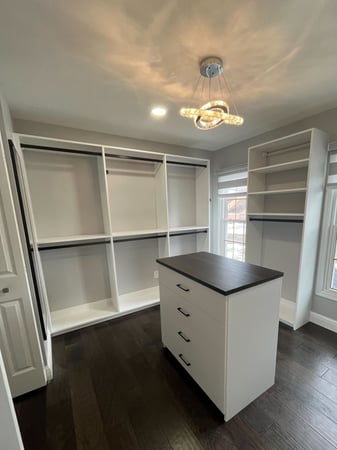 Custom Walk-in with an island and chandelier