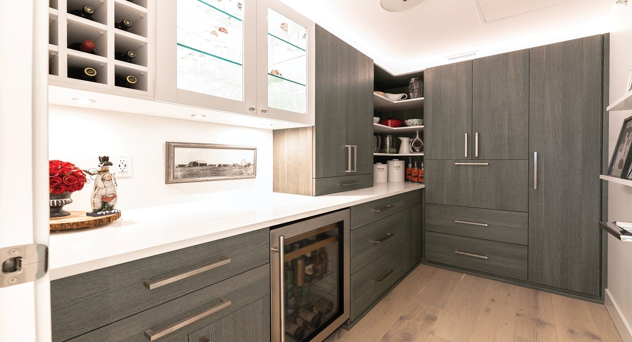 Custom walk-in pantry featuring kitchen pantry cabinets, drawers, shelving, and pantry organization storage solutions