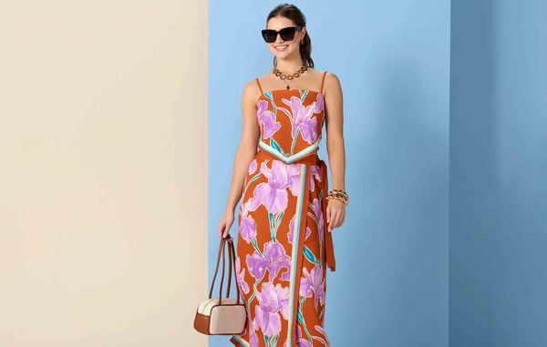 Woman is wearing a pink and orange floral matching set from Versona.