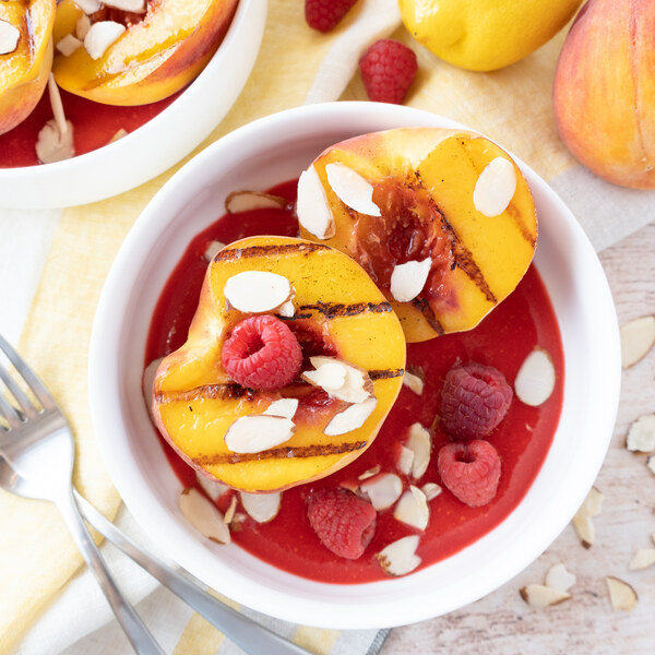 grilled peaches with raspberry sauce and almonds