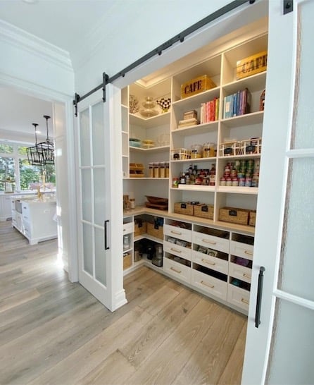 Custom, walk-in pantry with sliding barn door.