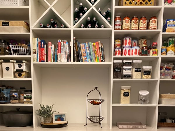 Kitchen pantry design featuring wine storage and varying pantry shelving to increase pantry organization by California Closets Toledo, Ohio.