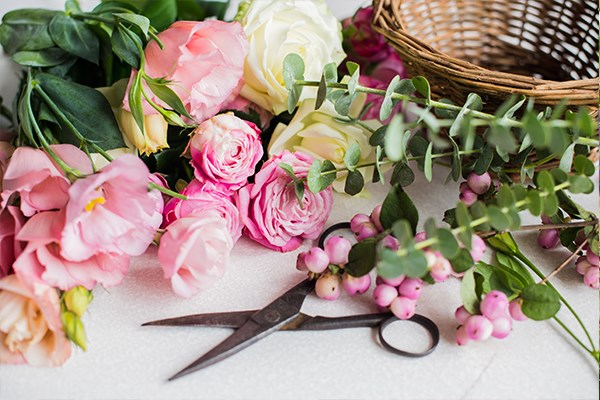 Funeral flowers awaiting preparation for a basket arrangement