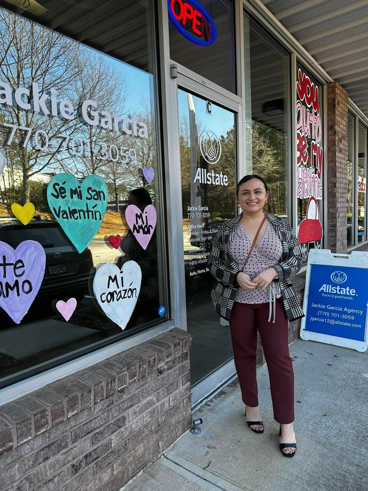 Jackie showing off the Agency window art!