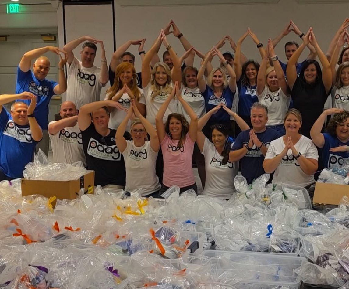 Local Gainesville, Va Allstate Agent Christine Angles volunteering alongside the positive national agent group where they raised $28,000 and packed over 1000 hygiene kits for survivors of domestic violence.