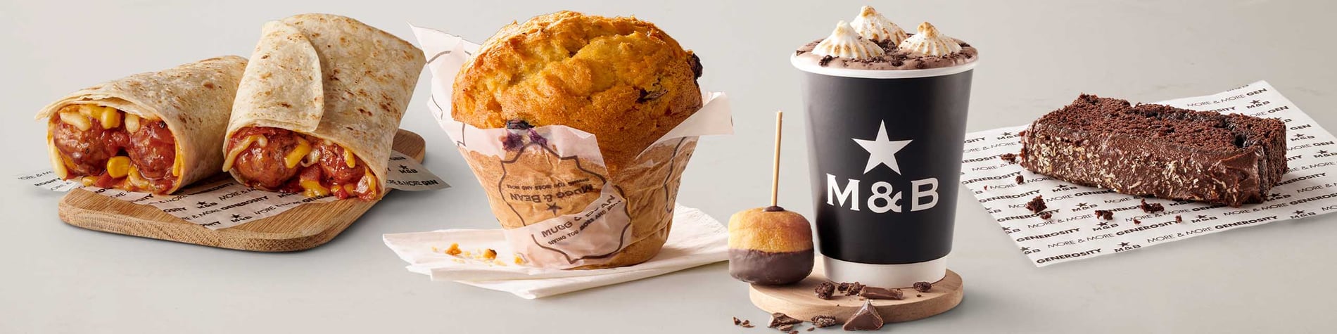 New takeaway meals from Mugg & Bean On-The-Move including a Marshmallow Cookies & Cream Hot Chocolate, a Swedish Meatball Wrap with pork meatballs, a slice of Coconut Chocolate Loaf Cake, and a freshly baked Blueberry Giant Muffin.