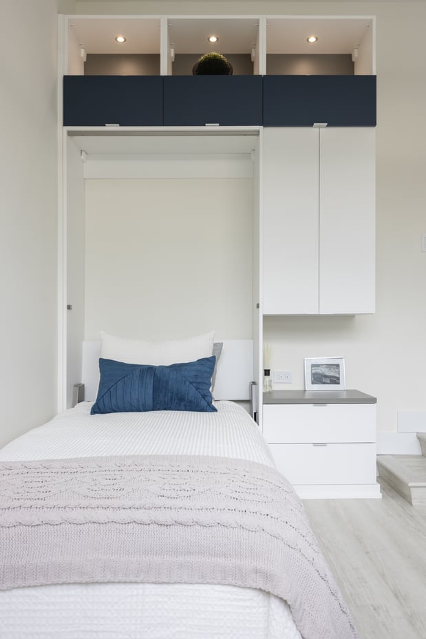 A front on view of murphy bed pulled out, with storage to the right and top