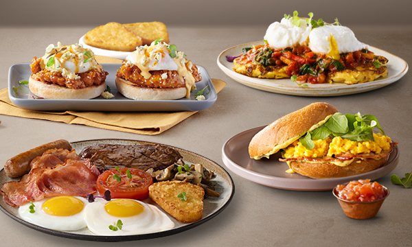 Range of breakfast and brunch meals on the Mugg & Bean Cavendish Square menu including the Buffalo Chicken & Blue Cheese Eggs Benedict, Hearty Grill Breakfast, Breakfast Bagel, and Sweet Potato Hash vegetarian breakfast.