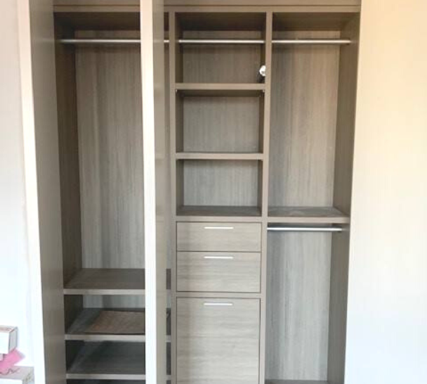 grey reach-in closet with hanging, shelving and drawers