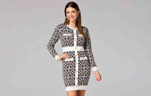 Woman is wearing a white and black pattern dress from Caché Collection at Versona