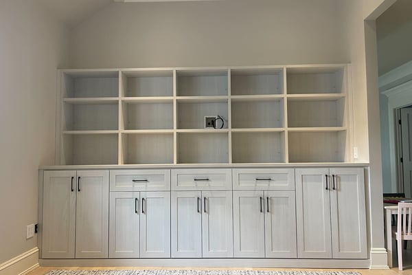 Light finish media center with open shelving, drawers and cabinets.