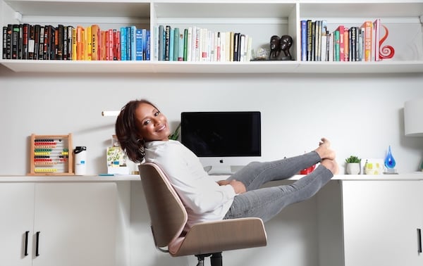 Custom home office with open shelving, cabinets and counter space in white wood finish by California Closets Chicago