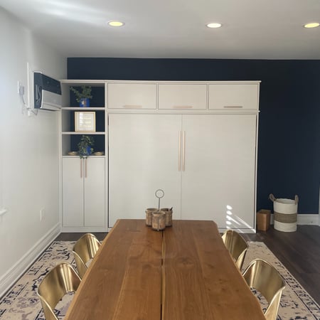 A hidden wall bed seamlessly integrated in a soft linen finish.