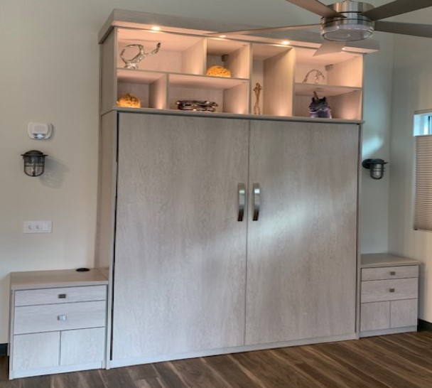 Wallbed and side tables incorporating lighted displays for precious items