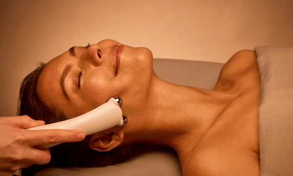 woman receiving a microcurrent facial