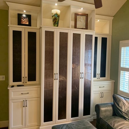 White media unit with displayed art and lighting