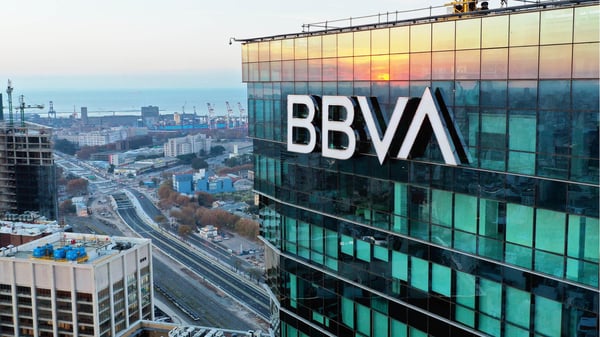 A Skyscraper with the BBVA USA Logo reflects sunset