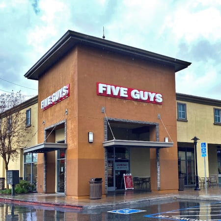 Exterior photograph of the Five Guys restaurant at 116 E. El Camino Real in Sunnyvale, California.